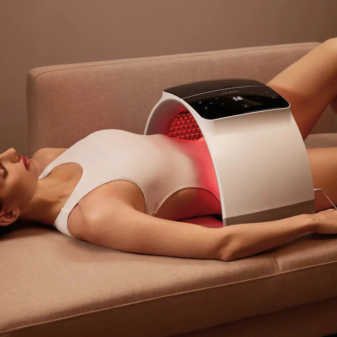 Woman laying on sofa under lumilux led spa over stomach 